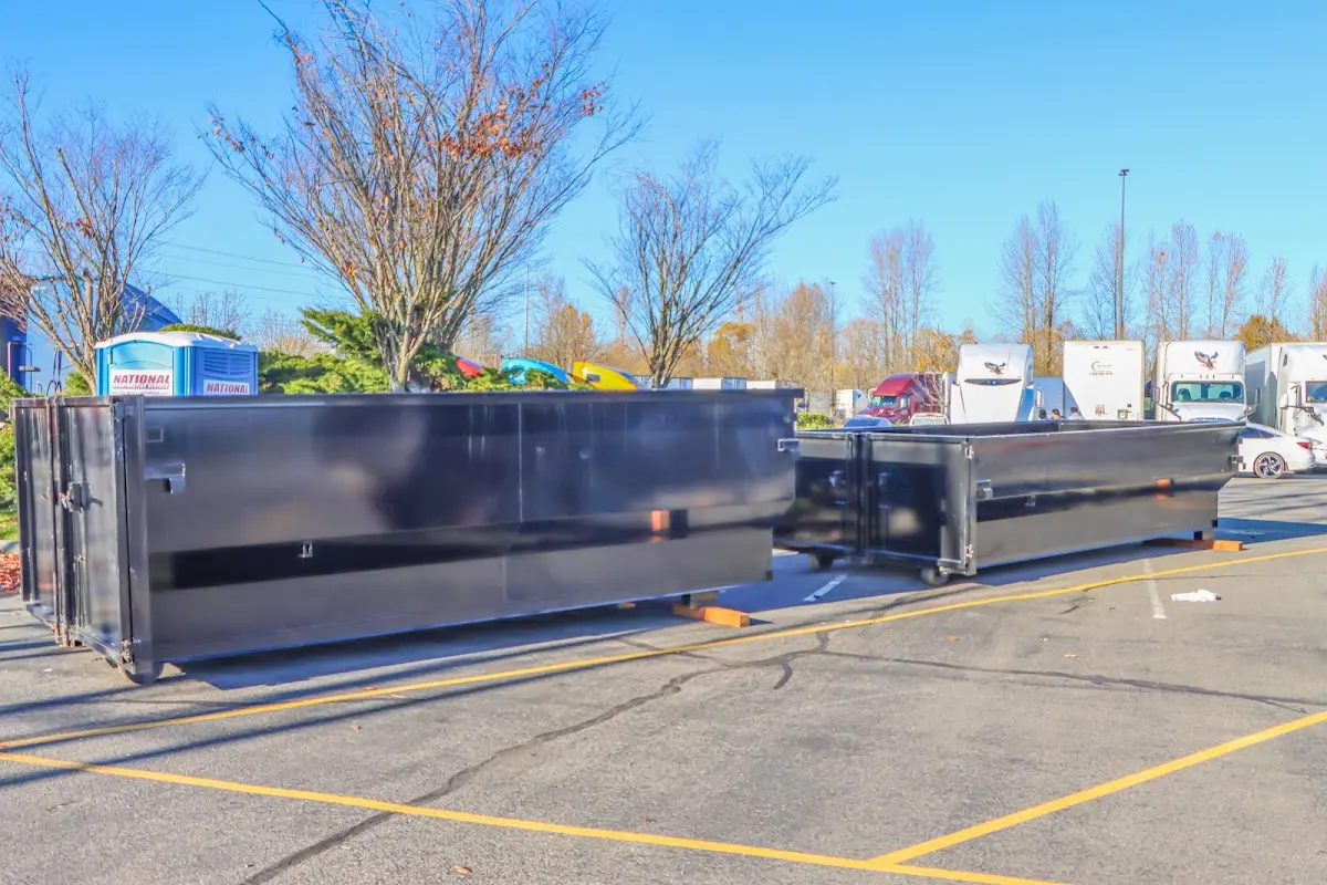 Professional dumpster rental service with roll-off container on residential driveway in Brooklyn Park